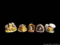 Front view showing five assembled animal-and-base pairs