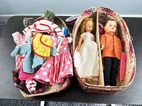 Open wardrobe case showing clothes bundle at left and both dolls in right compartments