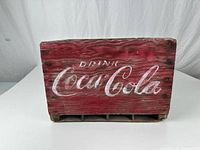 Front view showing red face with faded white Drink Coca-Cola script
