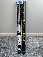 Two Westcott 7-ft parabolic umbrella carry tubes upright