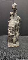 Front view of embracing nude figures sculpture