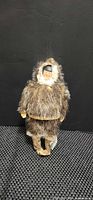Front view of fur-clad Inuit souvenir doll with hood up
