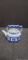Side view showing octagonal blue and white porcelain teapot with handle and spout