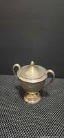 Front view of silver-plated two-handled sugar bowl with lid