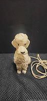 Front view of AN-SAN plastic poodle lamp with cord visible