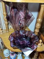 Amethyst art glass vase and bowl on shelf