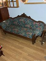 Full view of settee showing wood frame and upholstery