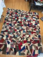 Full view of antique patchwork winter quilt laid flat