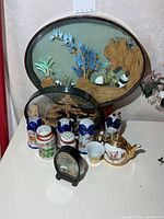 All items together: three cork dioramas, six shakers, teapot, teacup