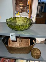 Metal basket holding copper tray and coaster set, green glass bowl visible