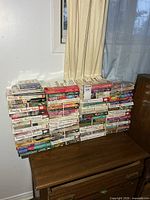 Front view of all paperback stacks on dresser