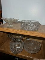 Group of five glass pieces on shelving