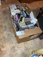 Cardboard box filled with many cassette tapes