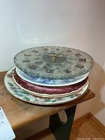 Stack showing glass clock on top of three plates