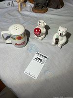 Full view of three Coca-Cola ceramic shakers