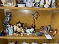 Shelf with metal owl, art glass bird, figurines, cobalt glass