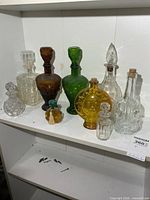 All eight glass vessels arranged on shelf