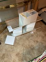 pair of mirrored shelves with white blocks and extra block shown