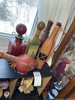 Group of five leather-wrapped bottles and round canteen displayed together