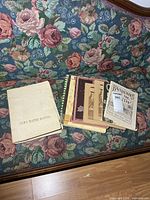 Stack and grouping of assorted local history books on floral sofa