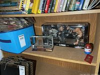 Shelf view showing blue matchbook bin, etched ship crystal, UFC 3-Pack, small capsule