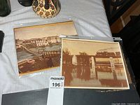 Both 8×10 photo prints in sleeves on table