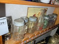 Shelf with eight sealer jars and one milk bottle
