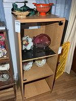 Front view of wood veneer stereo/display cabinet with shelves