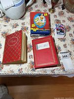 Overall lot with two red albums, Wonder Woman puzzle box, Marvel card stack