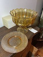 Amber glass pedestal trifle bowl and snack plate on wooden surface