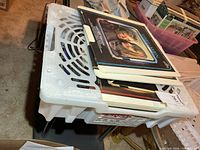 Crate filled with multiple CED video discs in plastic caddies