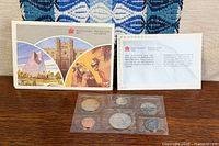 Outer illustrated envelope, spec card, sealed coin set displayed