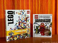 Front view of The LEGO Book slipcase beside LEGO Ninjago Character Encyclopedia