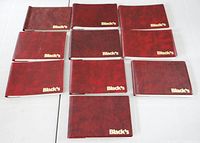 All ten red Black's mini photo albums laid out in two rows.