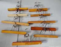 Top view showing all ten wooden clamp-style hangers laid out
