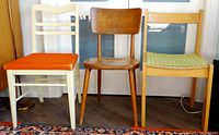Group image of three wooden chairs side by side