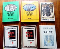 All six books laid out on wooden surface