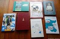 All seven books laid out front covers visible