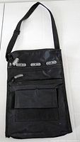 Full view of black Point Zero crossbody bag with strap