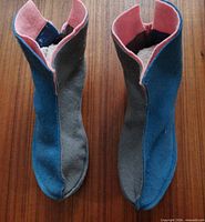 Top view of both slippers showing grey and blue sides and pink lining