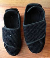 Top view of both slippers showing fabric texture and velcro straps