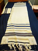 Full view of tallit laid out with bag