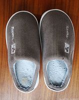 Top view of both slippers showing ribbed fabric, Lucky logo, overall condition