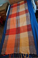 Full view of the wool plaid blanket on bed