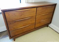 Front view showing six drawers and sculpted pulls