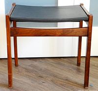 Front view of wood stool with black leather seat