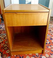 Front view of nightstand showing drawer closed and open shelf