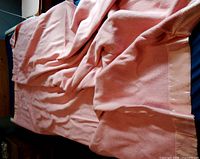 Full view of pink wool blanket on bed showing overall size