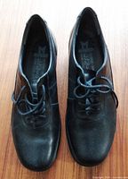 Top view of both Mephisto black leather shoes showing uppers and lacing