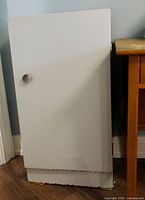 Front view of white metal cupboard